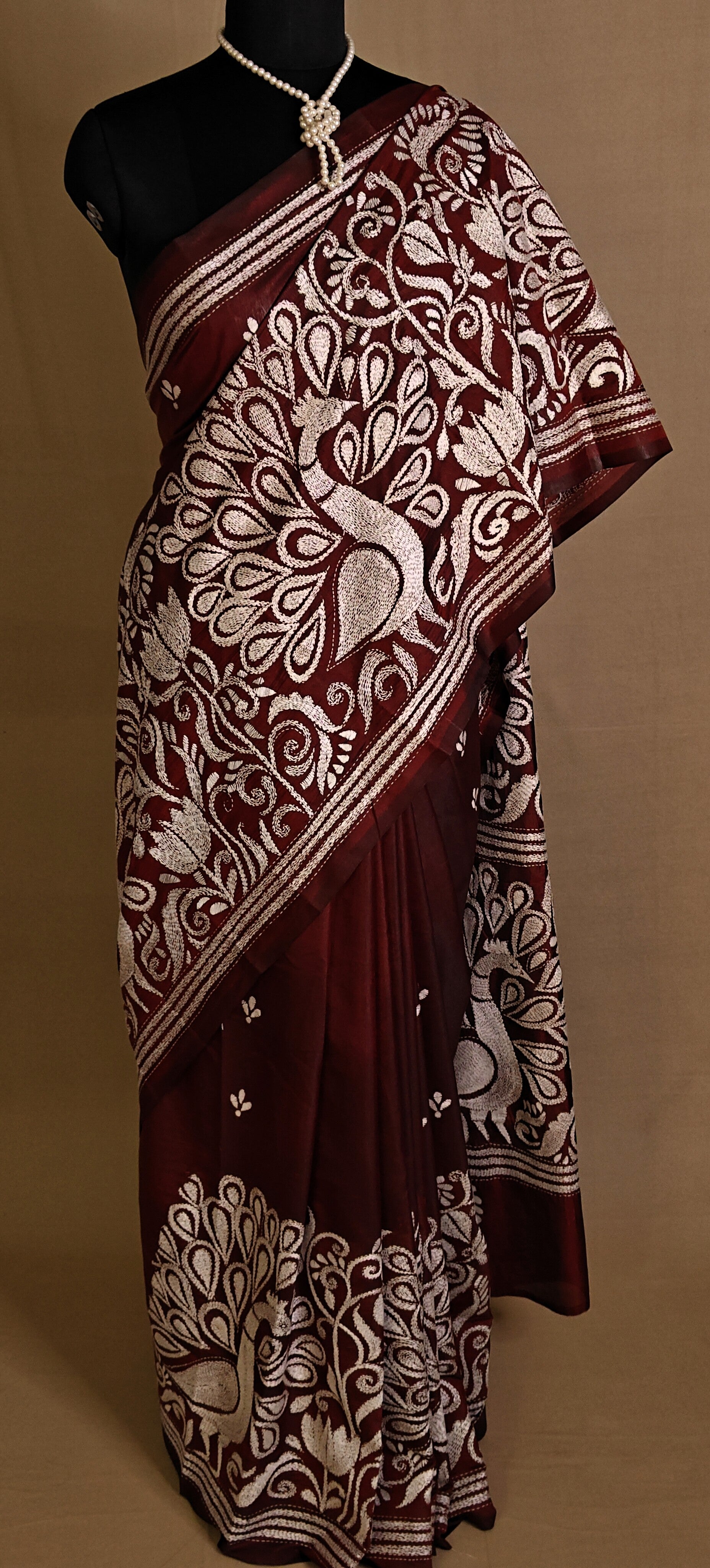 Luxury Kantha-Stitched Silk Saree – Red with Intricate Peacock & Floral Motifs saree draped on a mannequin.