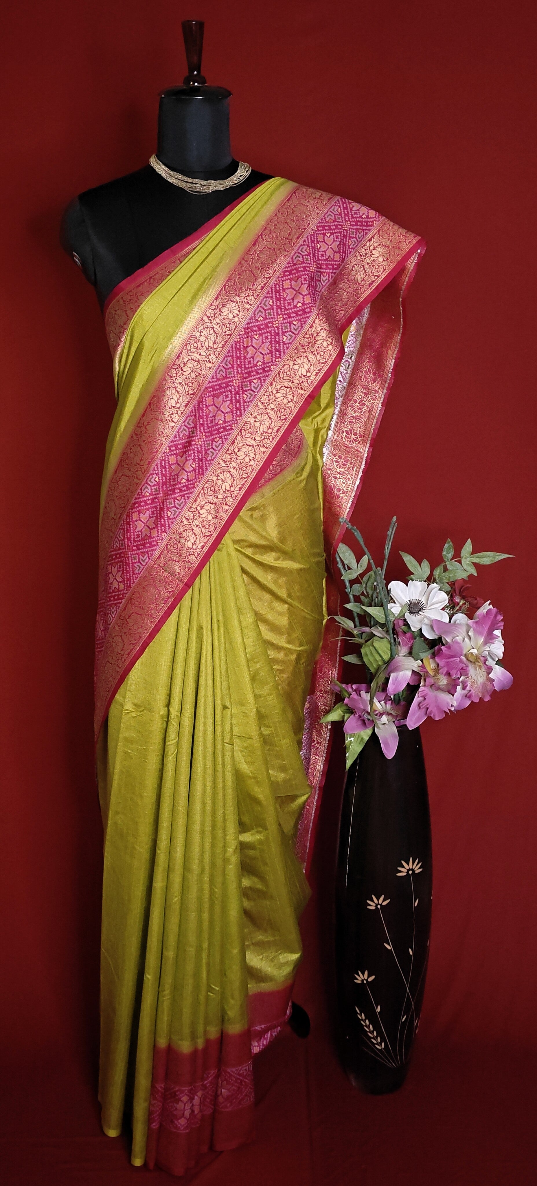Green Pochampally silk saree with traditional ikat weave and shimmering zari border.