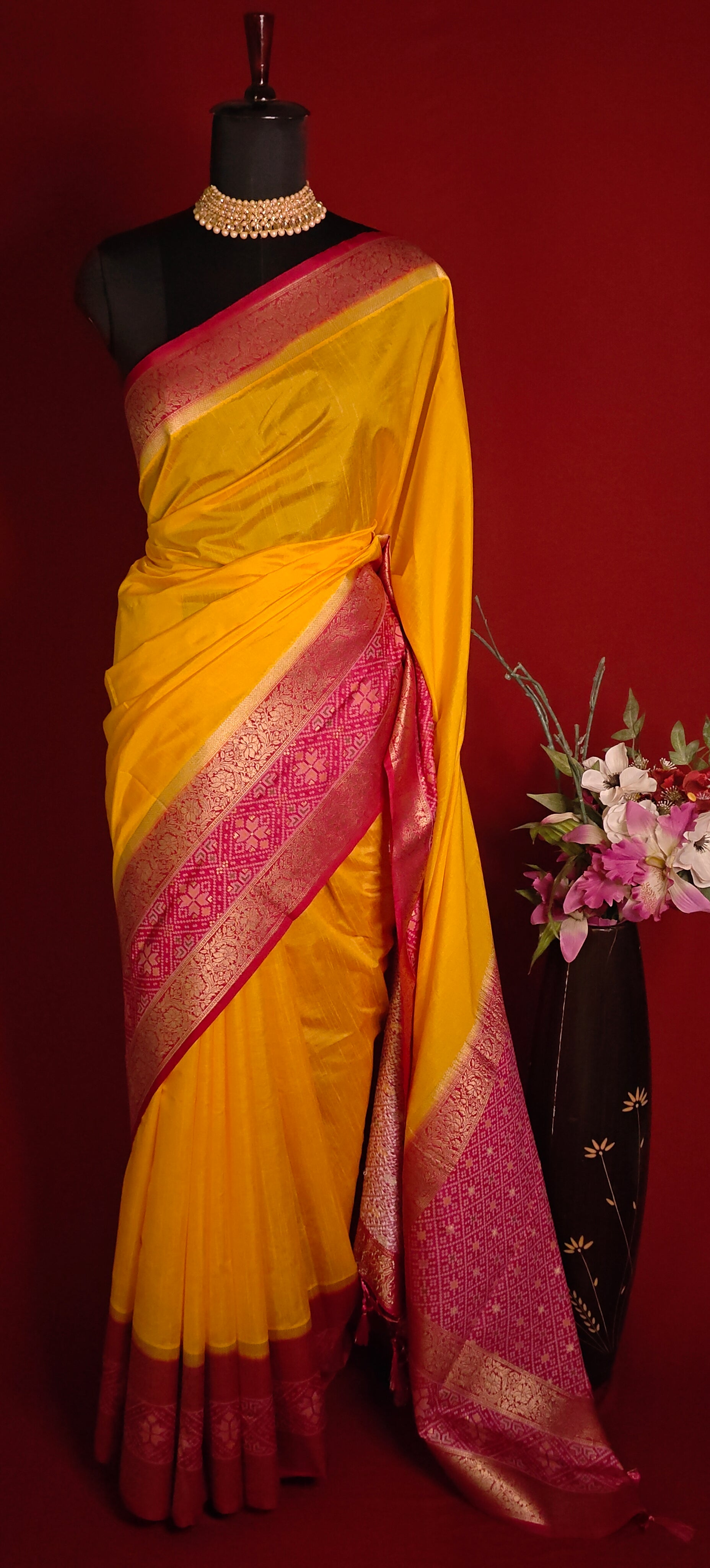 Bright yellow Pochampally silk saree with geometric ikat patterns and rich gold zari border.