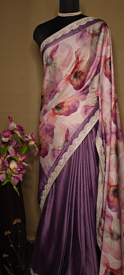 Strawberry silk saree with soft floral print and lace border, featuring deep purple pleats, displayed on mannequin with pearl necklace against a beige background.