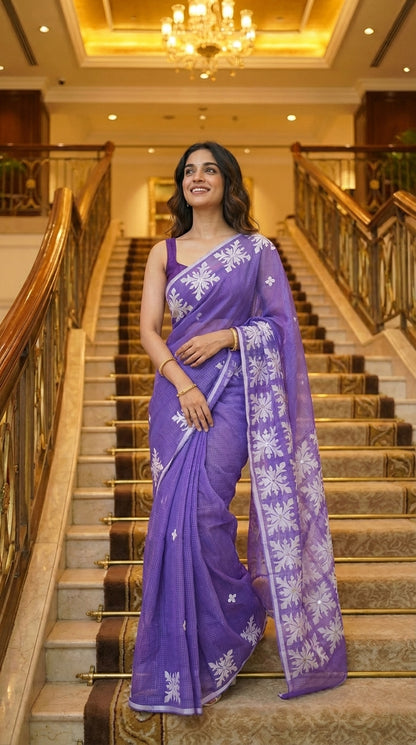 Woman in a purple-applique-kota-saree, standing on a staircase.