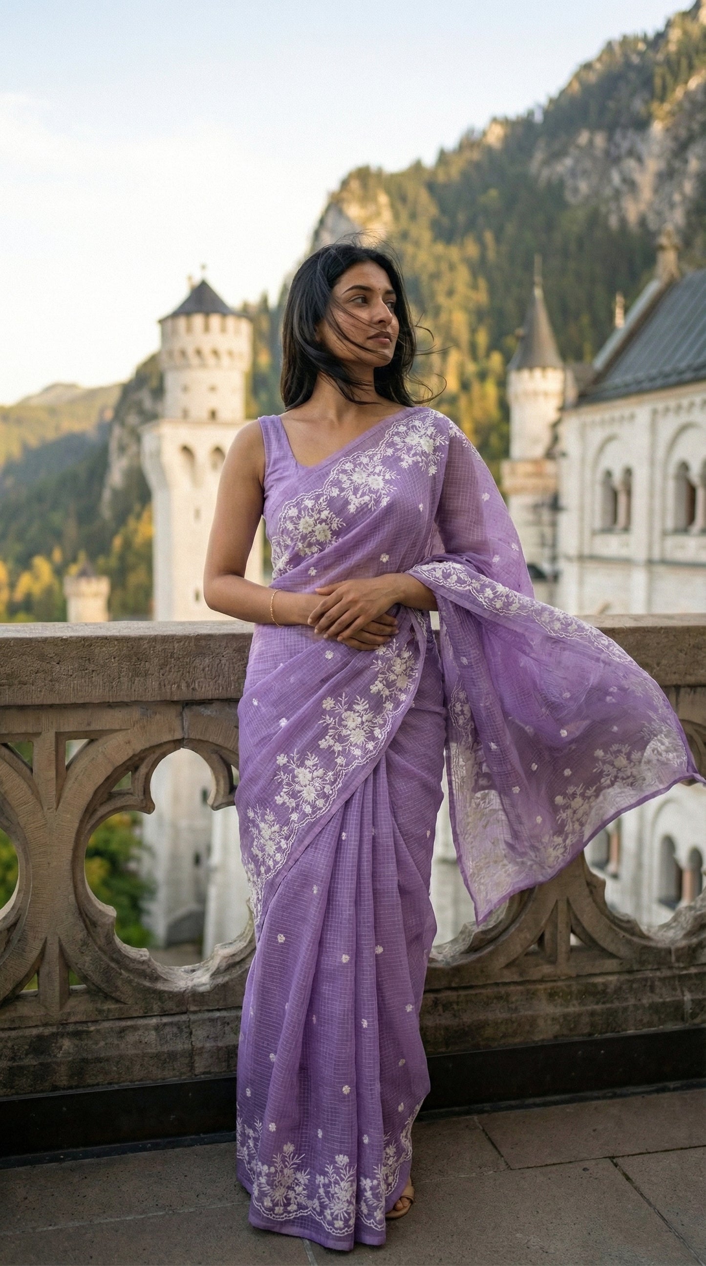Woman in a purple-resham-kota-cotton-saree, standing in front of Neuschwanstein Castle.