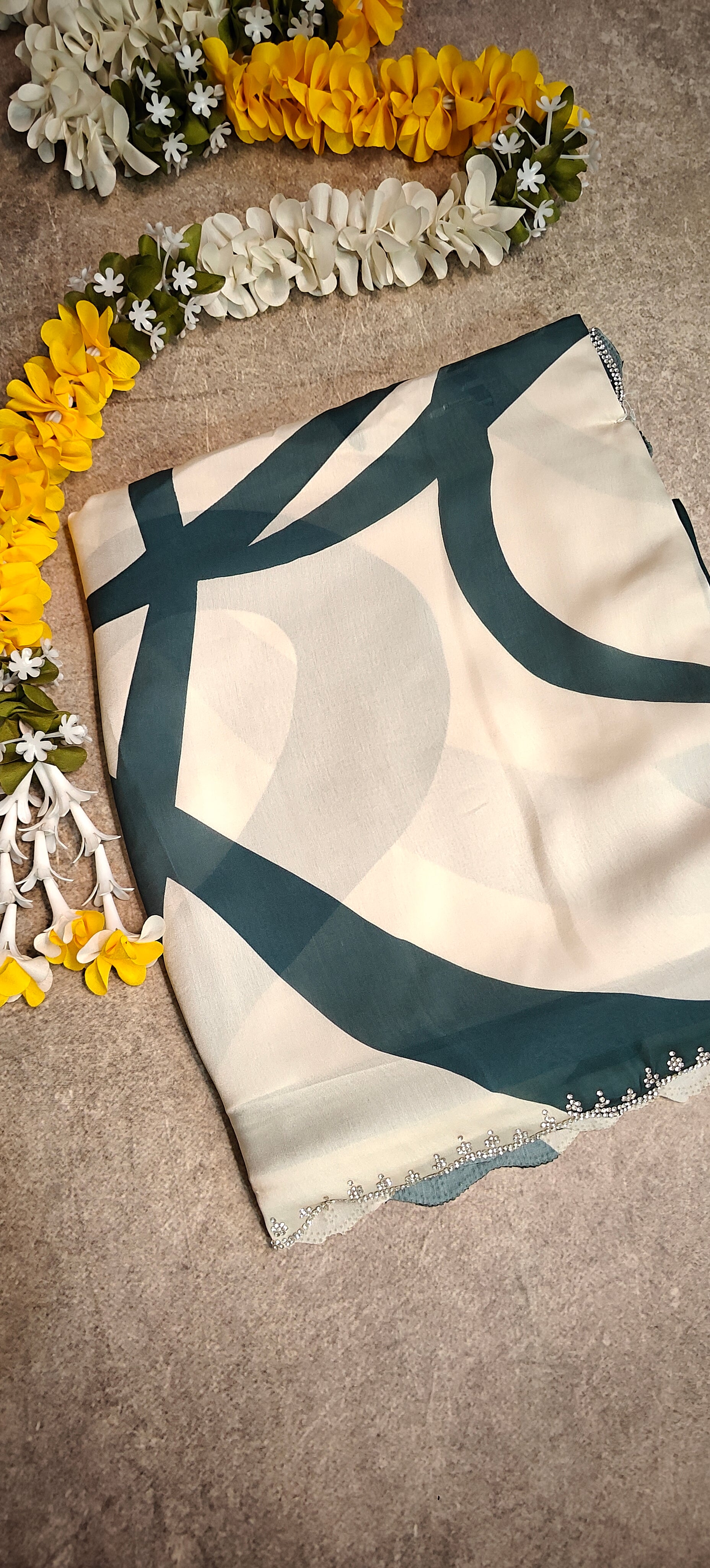 White satin-georgette saree with green abstract line pattern and embellished border, lightweight modern ethnic wear