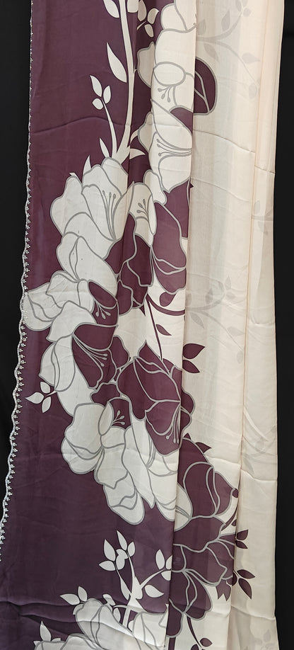 Wine red satin saree with large floral patterns and scalloped border, stylish festive saree with glossy drape.