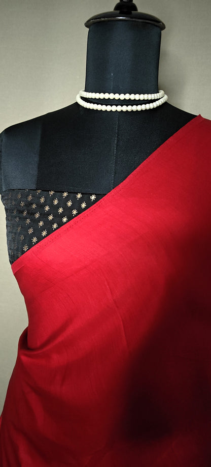 Strawberry silk saree with multicolor panelled design in red, green, black, yellow, and gold, displayed on mannequin with statement necklace. against a neutral background