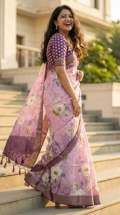 Woman wearing Lavender viscose silk blend saree with soft floral motifs, she is walking up a set of grand stairs, looking back while laughing, showing a beautiful spiral drape of the saree from the side.