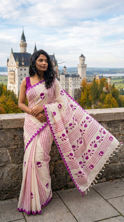 Woman in a white-cotton-saree-magenta-applique, standing in front of Neuschwanstein Castle.