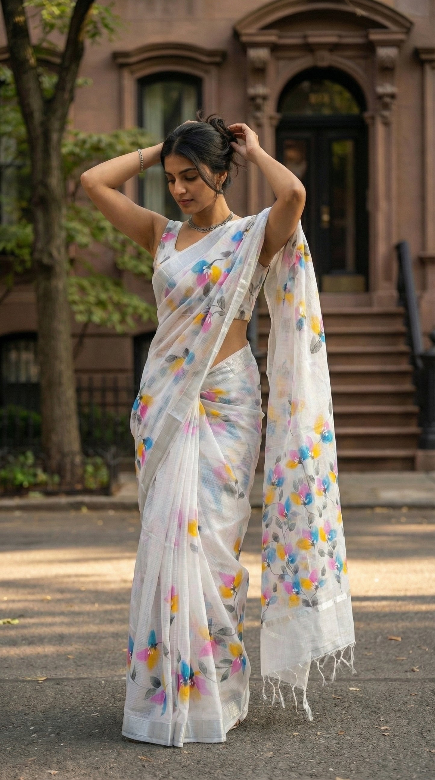 Woman in a white-hand-painted-saree-floral, in an urban setting