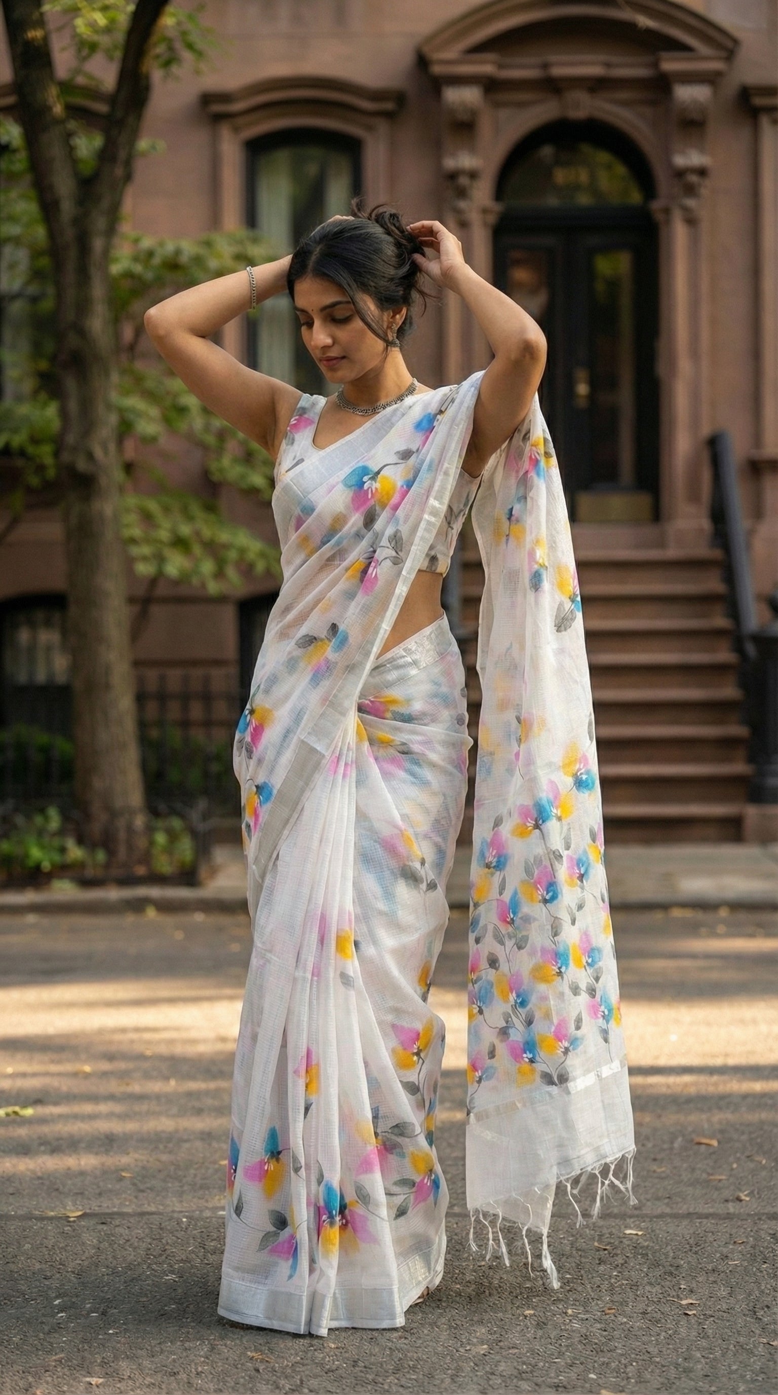 Woman in a white-hand-painted-saree-floral, in an urban setting